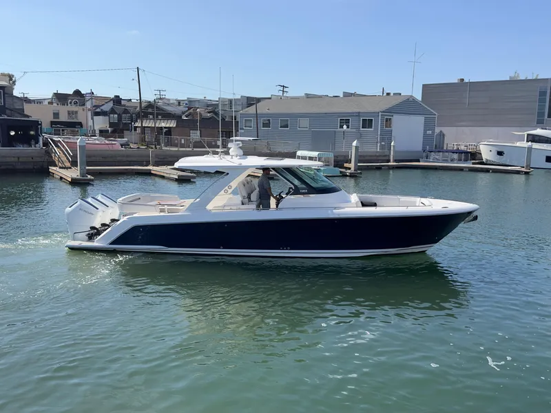 Slide: The Image of 2023 Tiara Yachts 38LS in marina, side view, calm water. - 2