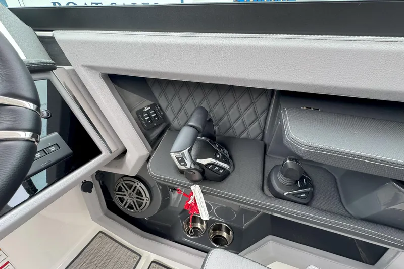 Slide: The Image of Interior of 2025 Cobalt R33 OB boat, featuring modern controls and sleek design. - 16