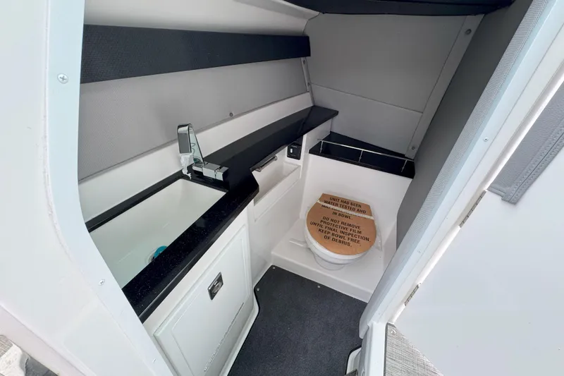 Slide: The Image of 2025 Cobalt R33 OB boat interior bathroom with sink and toilet. - 19