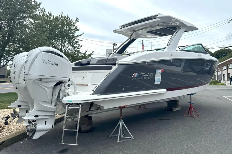 Slide: The Image of 2025 Cobalt R33 OB Coastal Edition boat on display with Yamaha engines. - 2