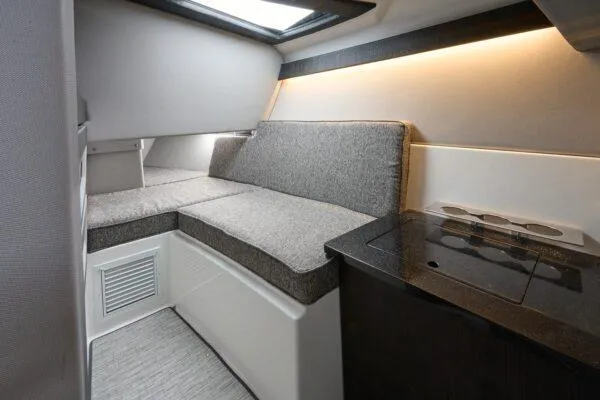 Slide: The Image of Interior of 2025 Cobalt R33 OB boat with modern seating and compact kitchenette. - 22