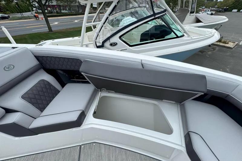 Slide: The Image of 2025 Cobalt R33 OB boat with open storage compartment and luxurious seating. - 25