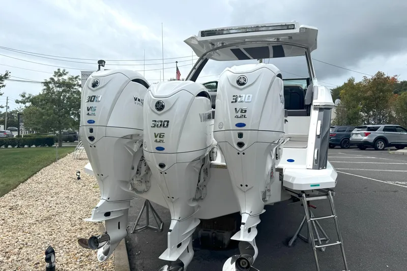 Slide: The Image of Triple Yamaha V6 outboard engines on a 2025 Cobalt R33 OB boat in a parking lot. - 3