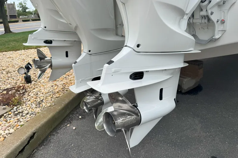 Slide: The Image of Dual outboard motors on a 2025 Cobalt R33 OB boat, featuring stainless steel propellers. - 5
