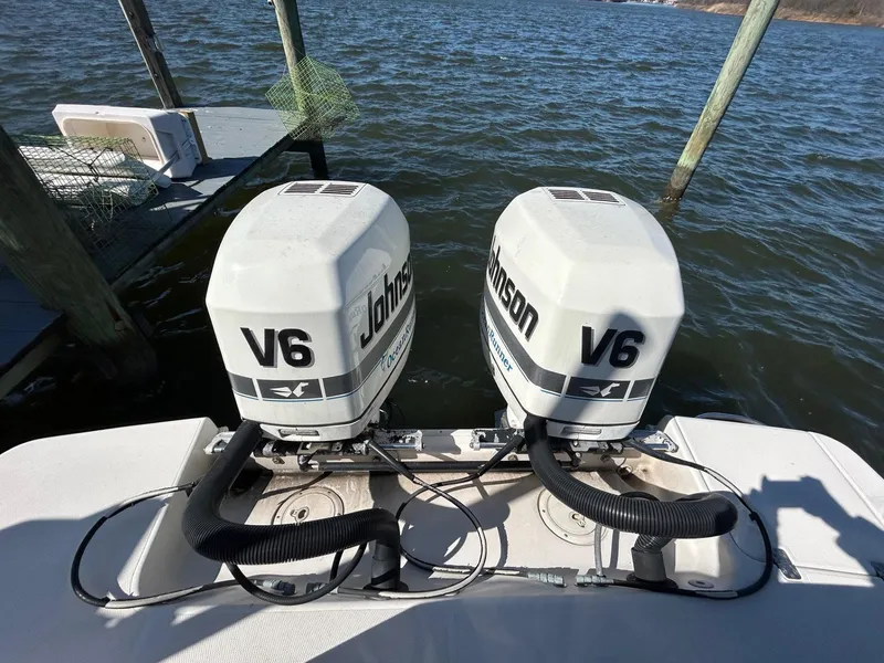 Slide: The Image of Twin Johnson V6 outboard engines on a 1997 Pro-Line 2810 Walkaround boat. - 10