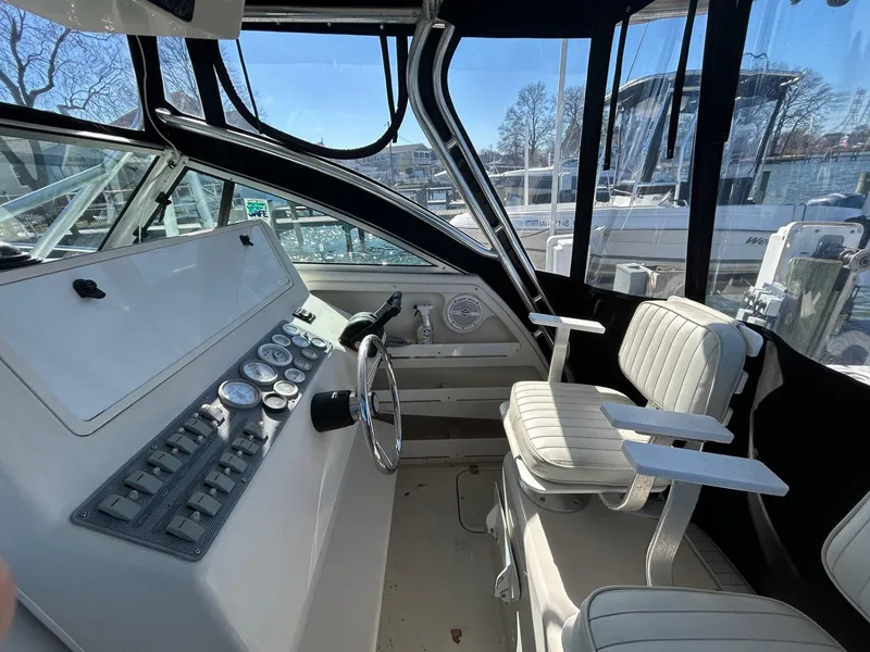 Slide: The Image of 1997 Pro-Line 2810 Walkaround boat interior with steering wheel and seating. - 13