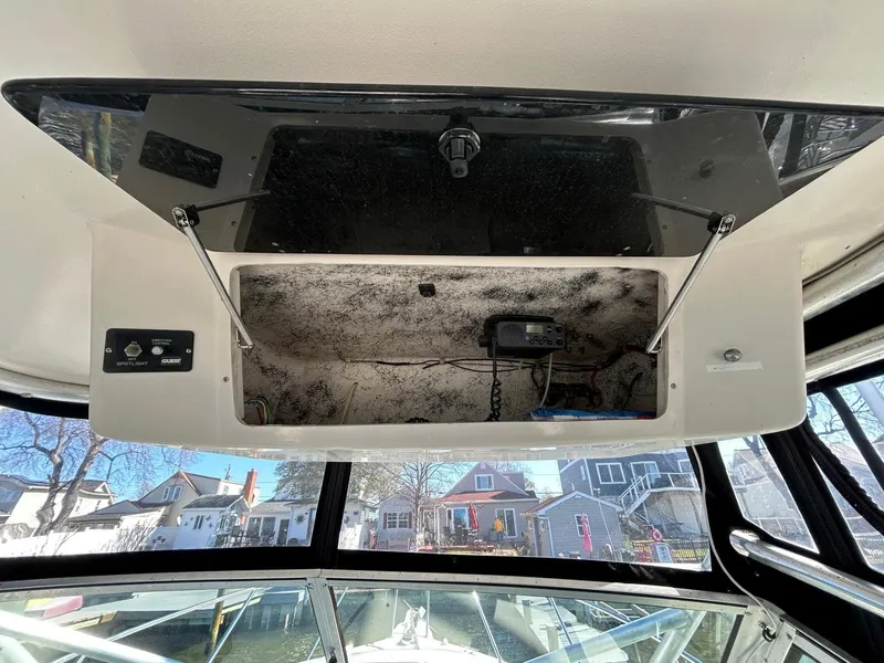 Slide: The Image of 1997 Pro-Line 2810 Walkaround boat interior with open storage compartment. - 16