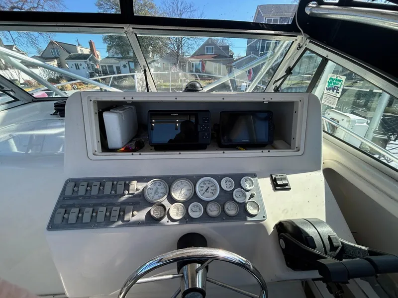 Slide: The Image of 1997 Pro-Line 2810 Walkaround boat dashboard with gauges and navigation equipment. - 17