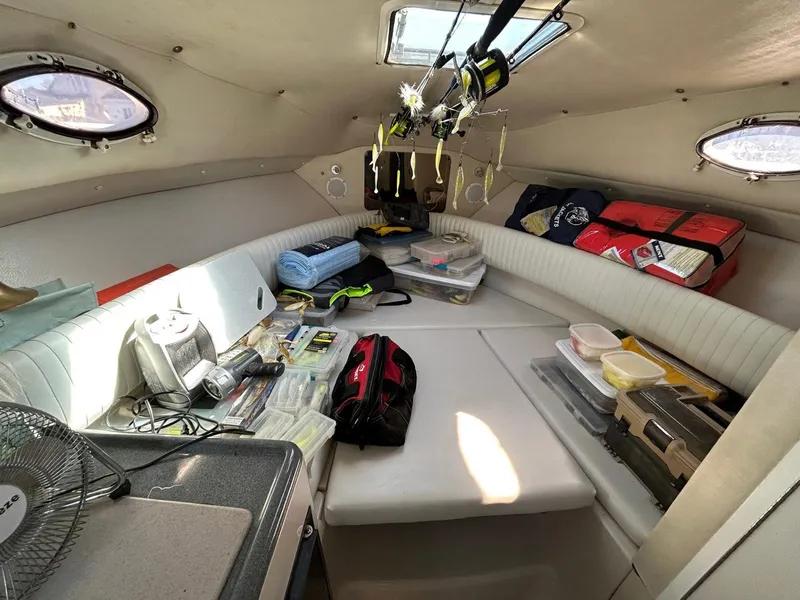 Slide: The Image of 1997 Pro-Line 2810 Walkaround cabin interior with fishing gear and supplies. - 22