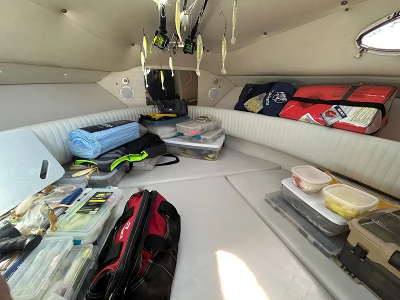 Slide: The Image of Interior of a 1997 Pro-Line 2810 Walkaround boat with fishing gear and supplies. - 24