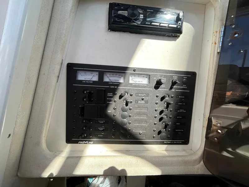 Slide: The Image of Control panel of a 1997 Pro-Line 2810 Walkaround boat, featuring various switches and gauges. - 27