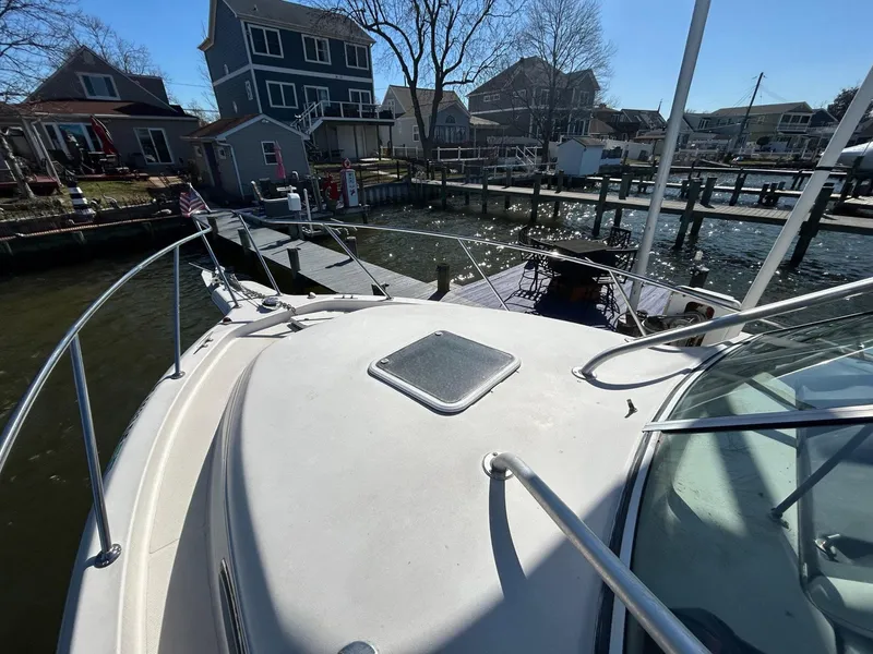 Slide: The Image of 1997 Pro-Line 2810 Walkaround boat docked near waterfront homes. - 29