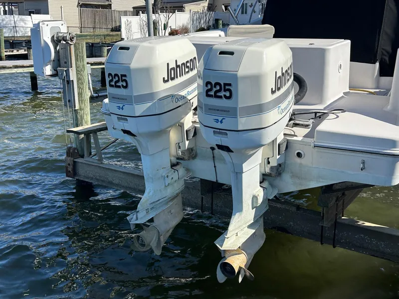 Slide: The Image of Twin Johnson 225 outboard motors on a 1997 Pro-Line 2810 Walkaround boat. - 6
