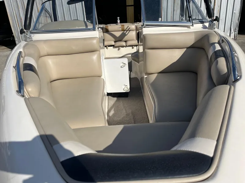 Slide: The Image of Interior of 2000 Tigé 2100V Limited boat with beige seating and steering wheel. - 4