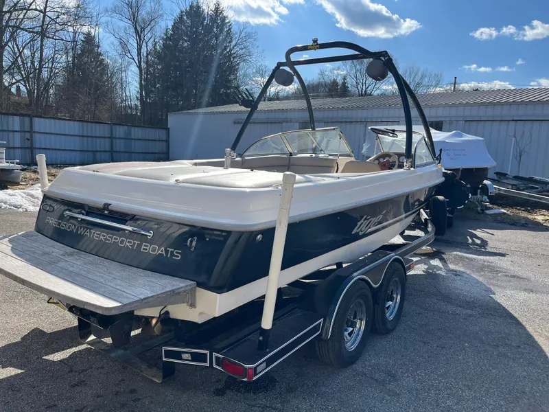 Slide: The Image of 2000 Tigé 2100V Limited boat on trailer, parked outdoors under a clear sky. - 5