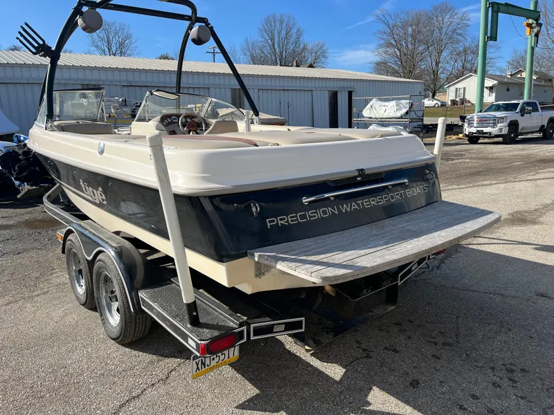 Slide: The Image of 2000 Tigé 2100V Limited boat on trailer, outdoor setting, rear view. - 6
