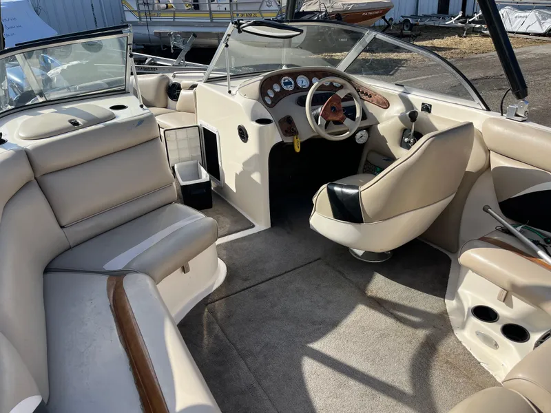 Slide: The Image of Interior of 2000 Tigé 2100V Limited boat with beige seating and steering console. - 9