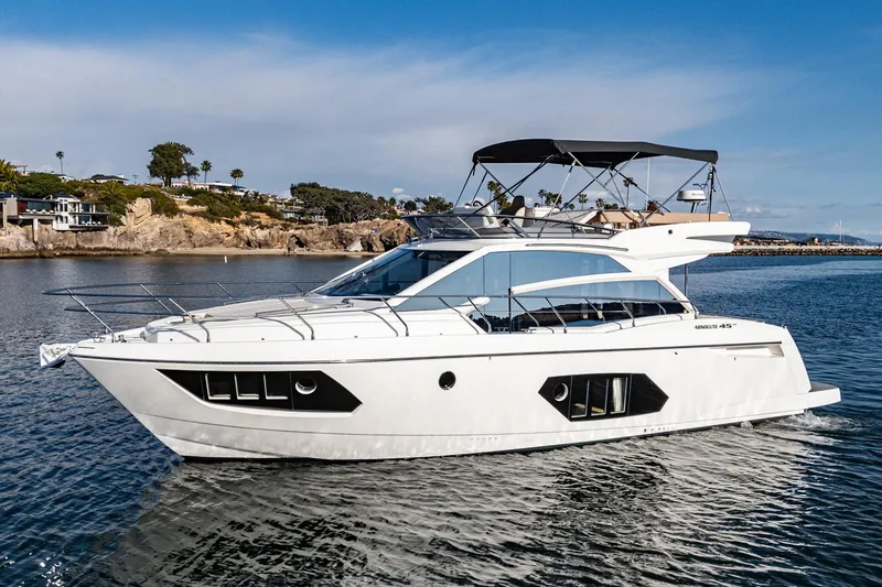 Slide: The Image of 2019 Absolute 45 FLY yacht cruising on calm waters, showcasing sleek design and luxury features. - 0