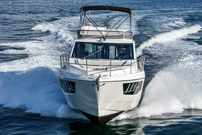 Slide: The Image of 2019 Absolute 45 FLY yacht cruising on open water, front view. - 10