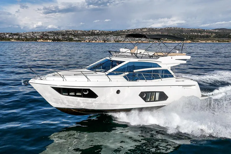 Slide: The Image of 2019 Absolute 45 FLY yacht cruising on open water, showcasing sleek design and luxury. - 13