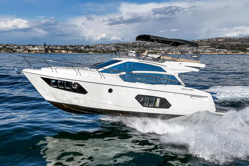Slide: The Image of 2019 Absolute 45 FLY yacht cruising on open water, showcasing sleek design and luxury. - 14