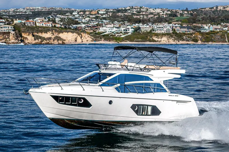 Slide: The Image of Luxury Absolute 45 FLY yacht cruising near scenic coastline, 2019 model. - 15