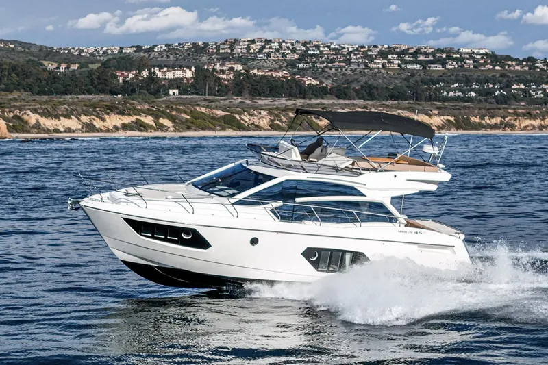Slide: The Image of 2019 Absolute 45 FLY yacht cruising on the ocean near a scenic coastline. - 16