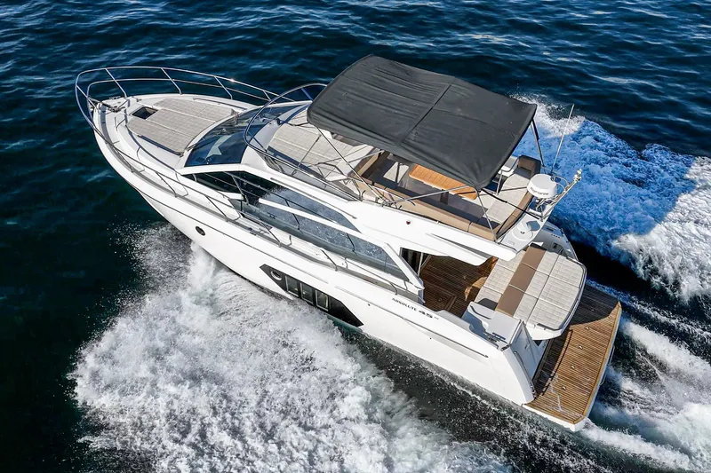 Slide: The Image of 2019 Absolute 45 FLY yacht cruising on open water, showcasing sleek design and luxury features. - 17