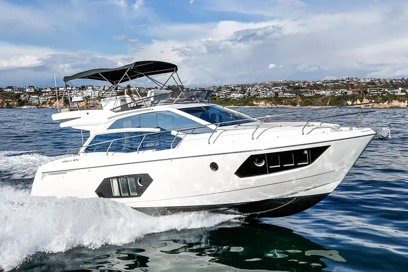 Slide: The Image of Luxury 2019 Absolute 45 FLY yacht cruising on open water. - 2