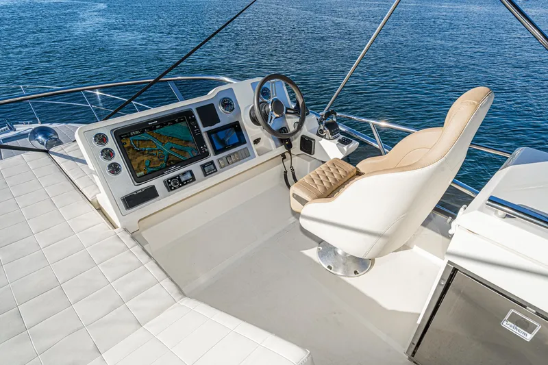 Slide: The Image of Flybridge helm of 2019 Absolute 45 FLY yacht with navigation screens and captain's chair. - 28