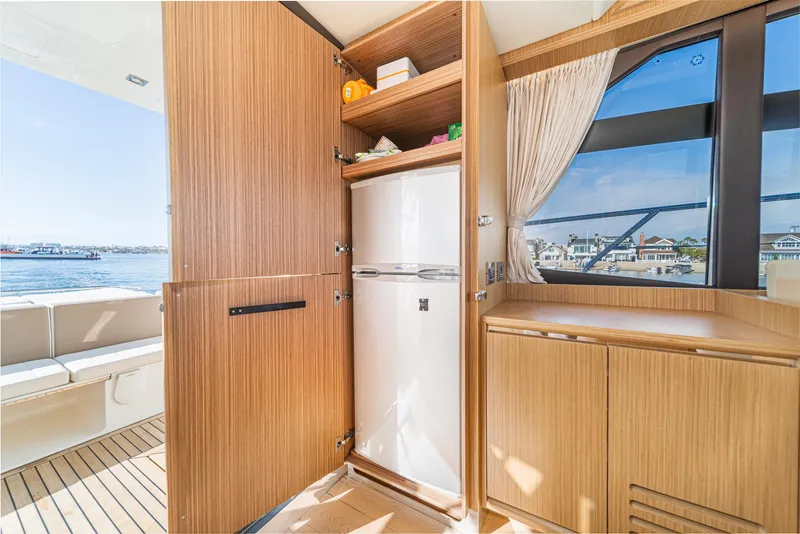 Slide: The Image of Interior of 2019 Absolute 45 FLY yacht with wooden cabinetry and ocean view. - 39