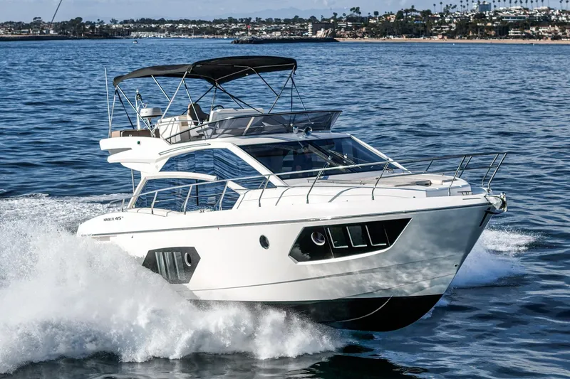 Slide: The Image of 2019 Absolute 45 FLY yacht cruising on open water, showcasing sleek design and luxury. - 4
