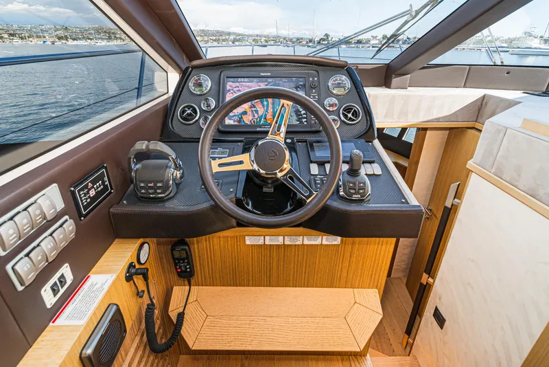 Slide: The Image of 2019 Absolute 45 FLY yacht helm with modern navigation controls and panoramic view. - 46