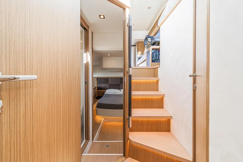 Slide: The Image of Interior of 2019 Absolute 45 FLY yacht, featuring modern design and wooden staircase. - 48