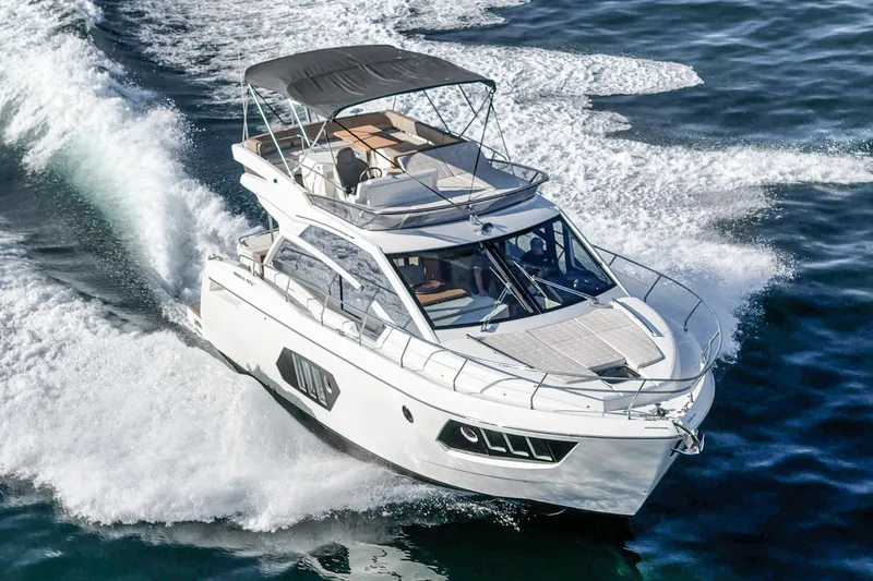 Slide: The Image of 2019 Absolute 45 FLY yacht cruising on open water, showcasing sleek design and luxury. - 5