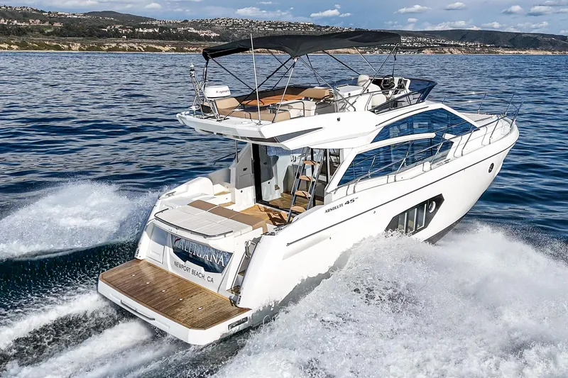 Slide: The Image of 2019 Absolute 45 FLY yacht cruising on open water, showcasing sleek design and luxury features. - 7