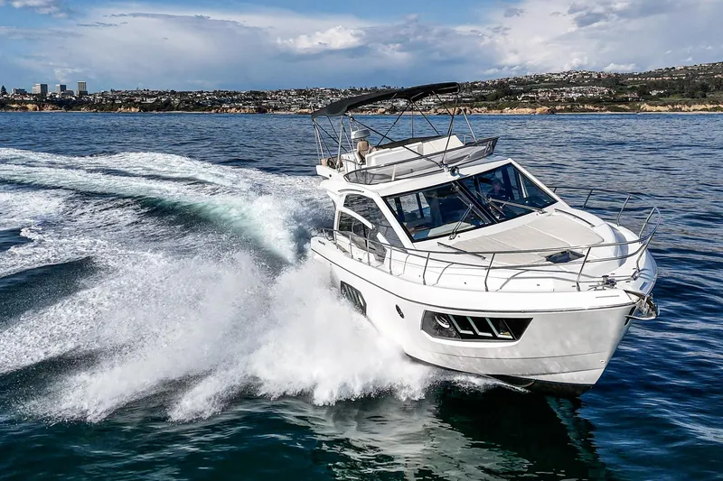 Slide: The Image of 2019 Absolute 45 FLY yacht cruising on open water, creating a dynamic wake. - 9