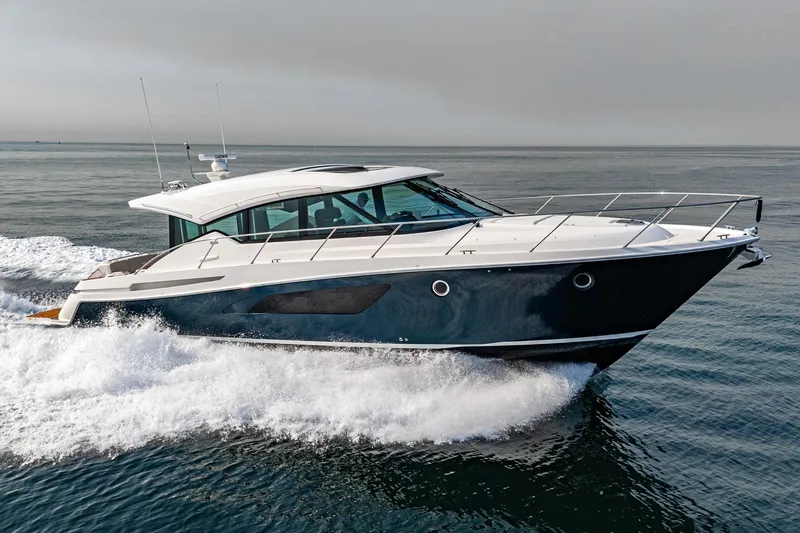 Slide: The Image of 2021 Tiara Yachts 53 Coupe cruising on open water, showcasing sleek design and performance. - 18