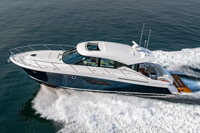 Slide: The Image of 2021 Tiara Yachts 53 Coupe cruising on open water, showcasing sleek design and luxury. - 19