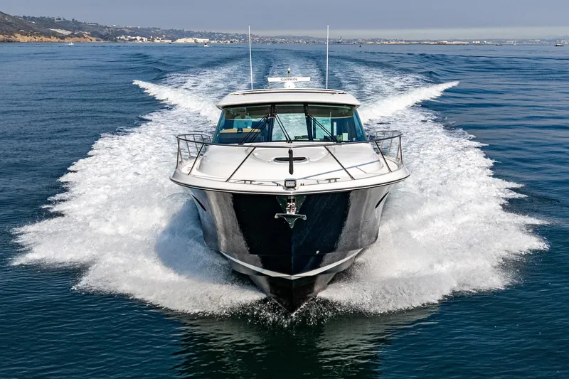 Slide: The Image of 2021 Tiara Yachts 53 Coupe cruising on open water, front view. - 21