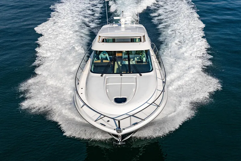 Slide: The Image of 2021 Tiara Yachts 53 Coupe cruising on open water, aerial view. - 22