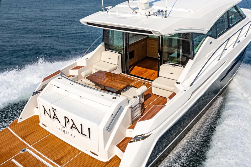 Slide: The Image of 2021 Tiara Yachts 53 Coupe cruising on water, featuring elegant deck and seating area. - 28