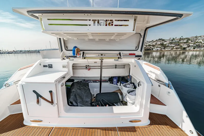 Slide: The Image of 2021 Tiara Yachts 53 Coupe storage compartment with open hatch, dockside view. - 29