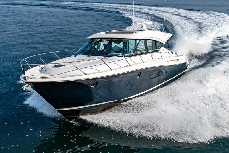 Slide: The Image of 2021 Tiara Yachts 53 Coupe cruising on open water, showcasing sleek design and performance. - 3