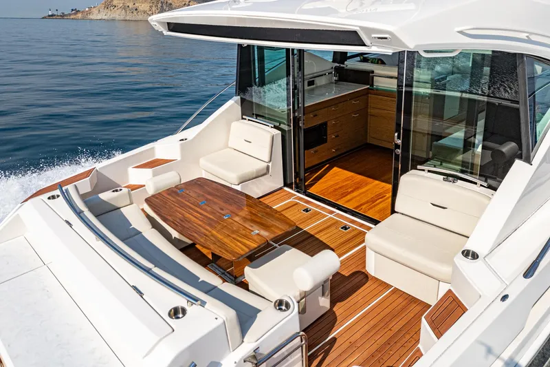 Slide: The Image of 2021 Tiara Yachts 53 Coupe with elegant outdoor seating and wooden deck. - 31