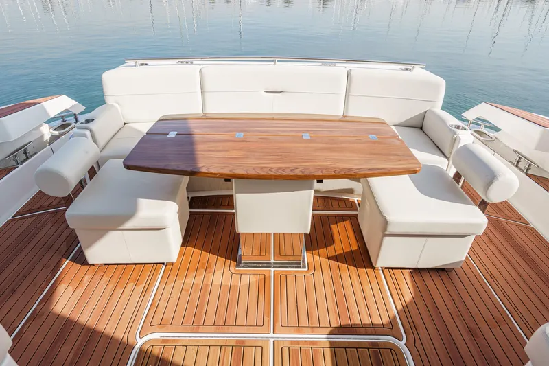 Slide: The Image of Luxurious seating area on 2021 Tiara Yachts 53 Coupe with elegant wooden table. - 33