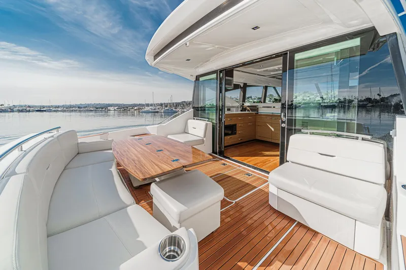 Slide: The Image of 2021 Tiara Yachts 53 Coupe with elegant deck seating and scenic marina view. - 35
