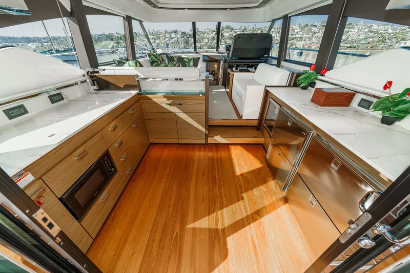 Slide: The Image of Luxurious interior of 2021 Tiara Yachts 53 Coupe with modern kitchen and panoramic windows. - 38
