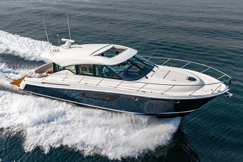 Slide: The Image of 2021 Tiara Yachts 53 Coupe cruising on open water, showcasing sleek design and luxury. - 4
