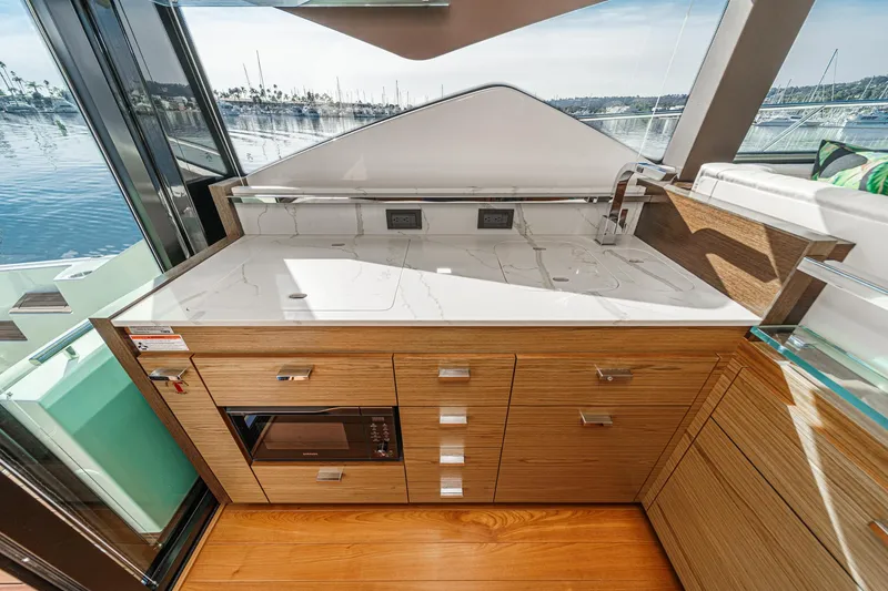 Slide: The Image of Modern kitchen area on 2021 Tiara Yachts 53 Coupe with sleek cabinetry and appliances. - 42